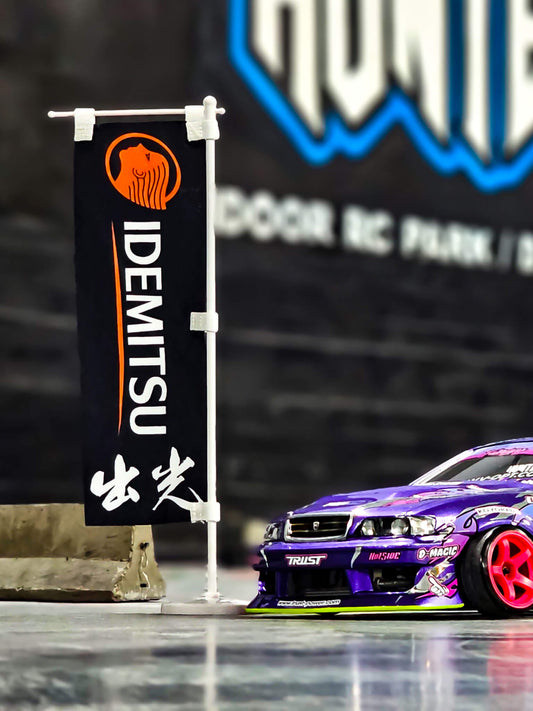 Idemitsu Oil Mini Nobori Flag with Stand posed next to RC Car